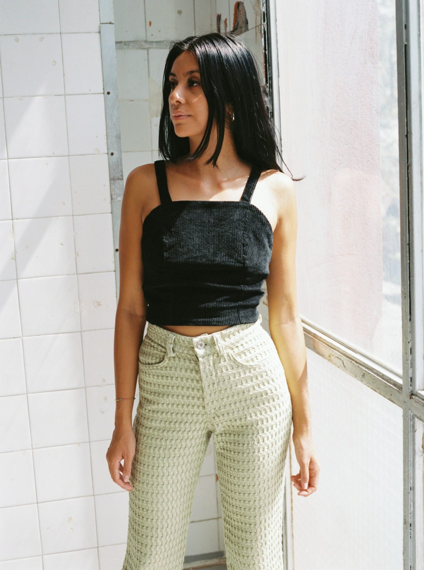 High-waisted waffle trousers with a straight leg, back pockets, belt loops, metal zip, and vintage button closure. Made from deadstock organic cotton waffle fabric. Made in Barcelona. 100% Organic Cotton.