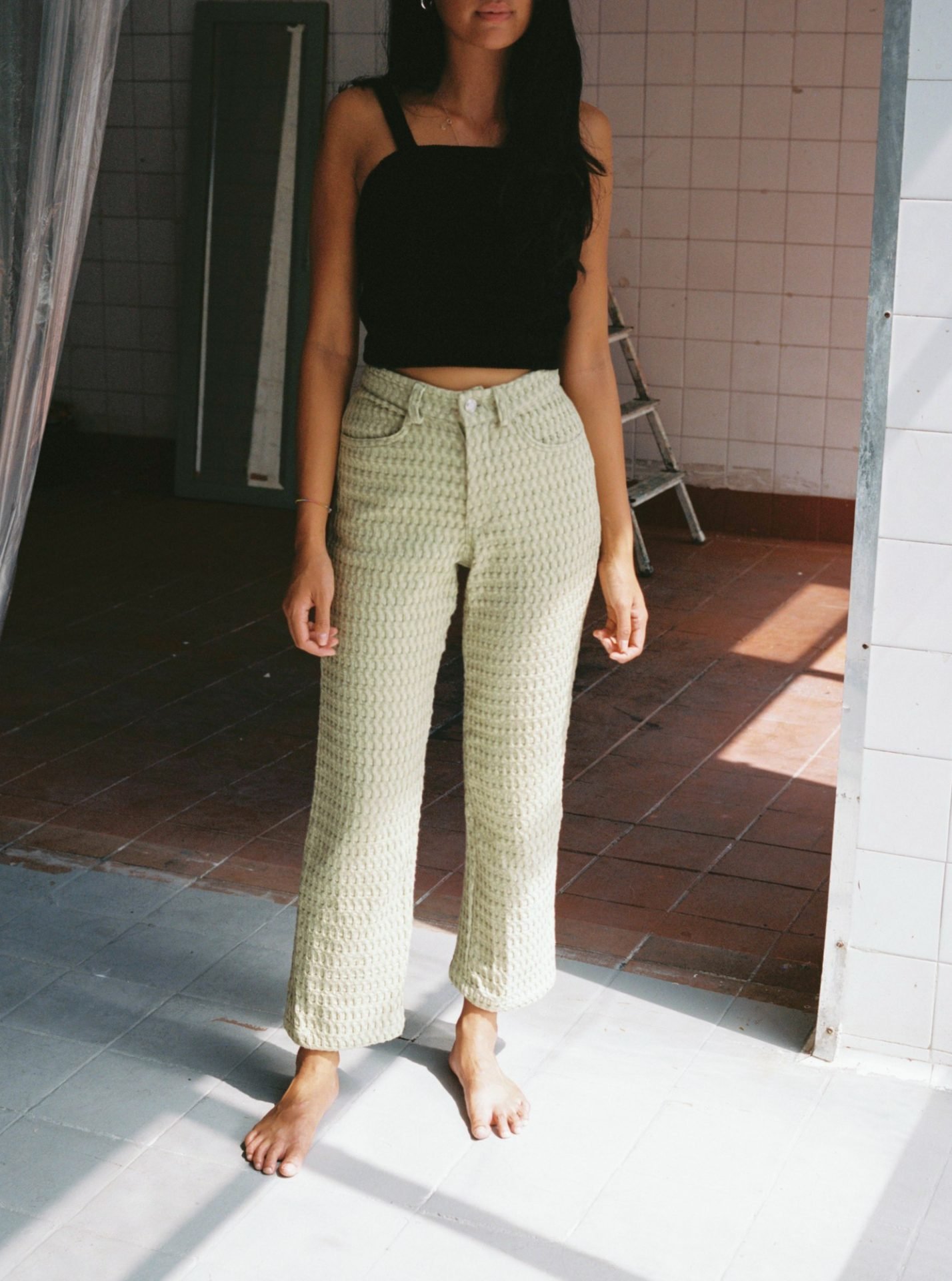 High-waisted waffle trousers with a straight leg, back pockets, belt loops, metal zip, and vintage button closure. Made from deadstock organic cotton waffle fabric. Made in Barcelona. 100% Organic Cotton.